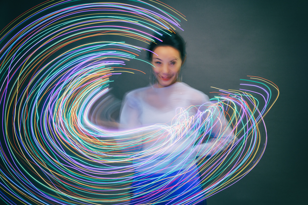 Ying Wang surrounded by multicoloured light trails during 528 Hz